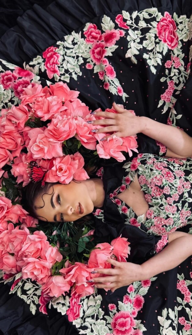 Photo of the model posing with a flowers